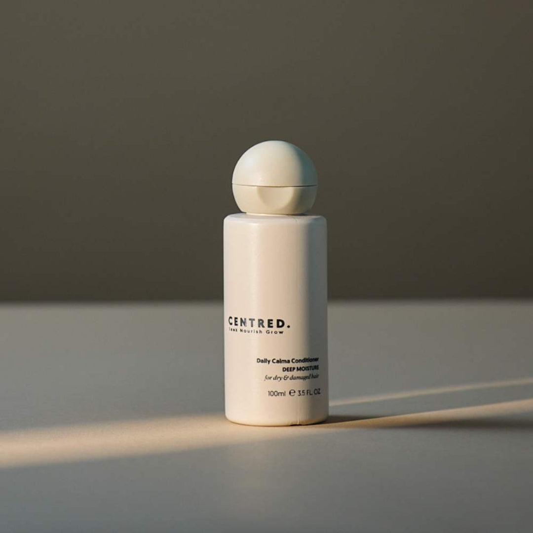 White bottle with spherical cap on a gray surface and background