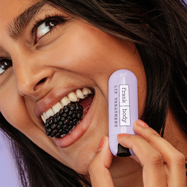 Woman applying blackberry-flavored lip balm to her lips