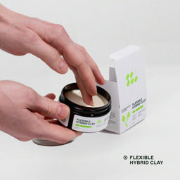 Person opening a jar of flexible hybrid clay with a box next to it on a white background