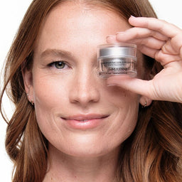 A model holding a jar over their eye