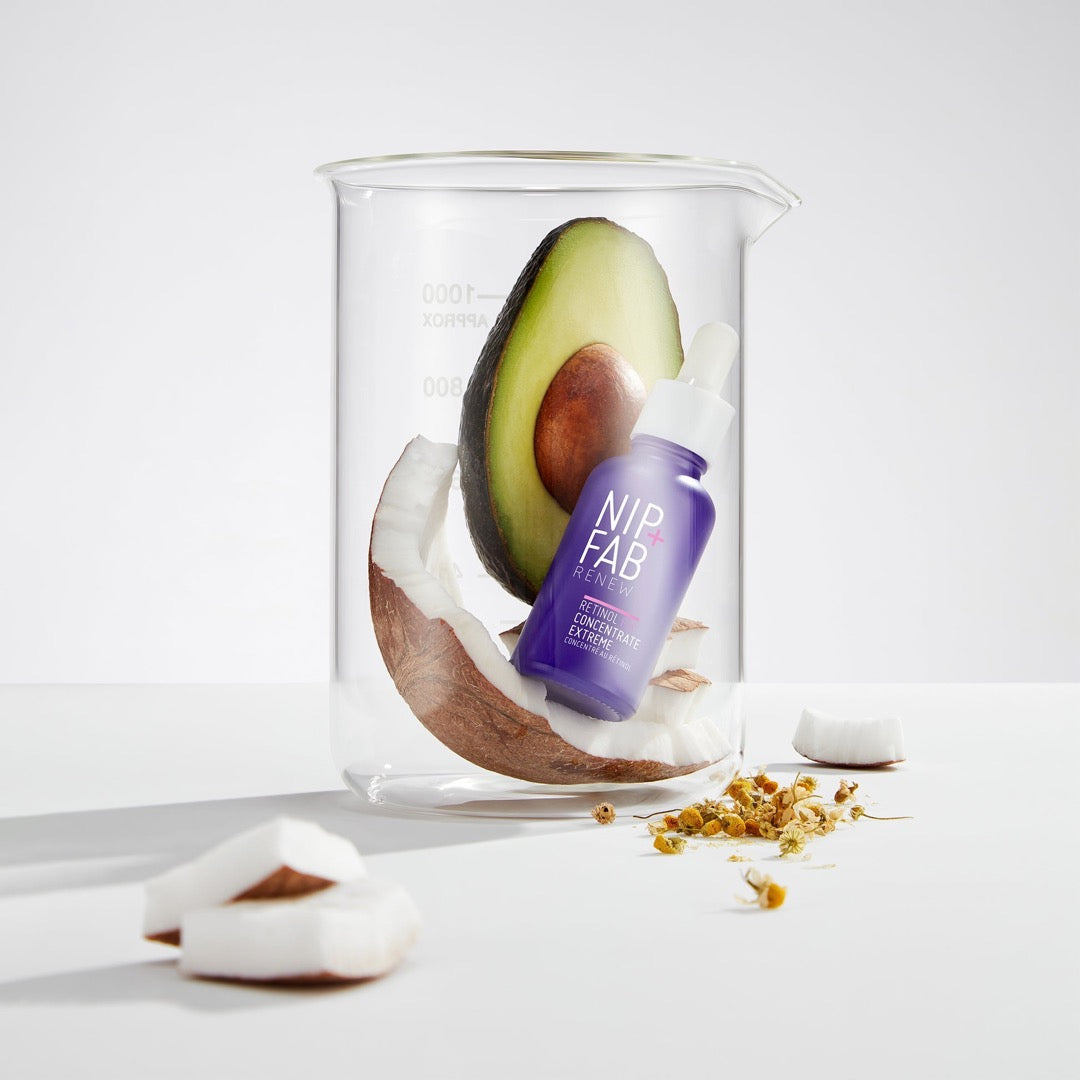 Nip+Fab Retinol Fix Booster Extreme with a half of coconut and avocado in a glass jar